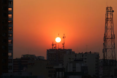 Buildings in city at sunset