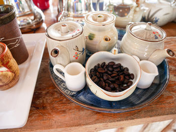 High angle view of coffee and cups on table