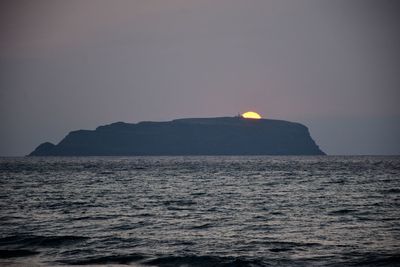 Scenic view of sea against clear sky during sunset