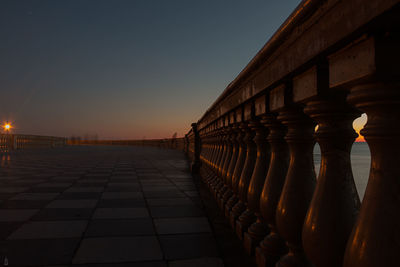 Row of bridge against sky during sunset