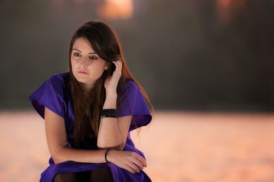 Portrait of young woman standing outdoors