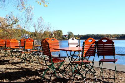 View of chairs on beach against clear sky
