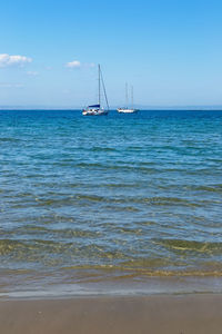 Sailboat sailing on sea against sky