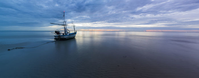 Sailboat in sea against sky