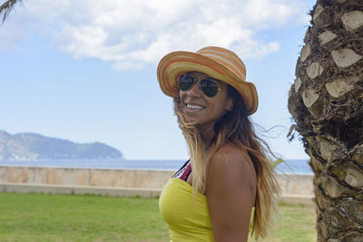 Beautiful and happy latin woman with long hair smiling, having a good time, on vacation in mallorca 