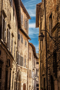 Low angle view of buildings in town against sky