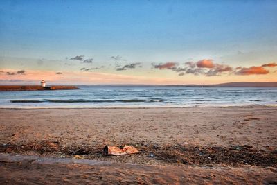 Scenic view of beach against sky during sunset