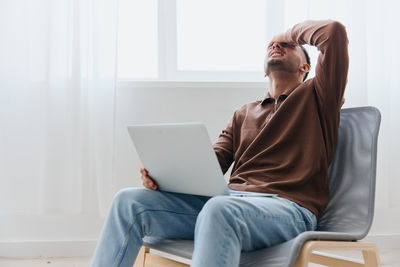 Young woman using laptop at home