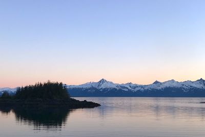 Scenic view of lake and mountains against clear sky