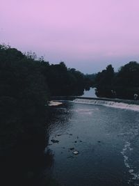 Scenic view of trees against sky at sunset