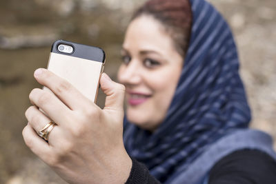 Midsection of woman using mobile phone