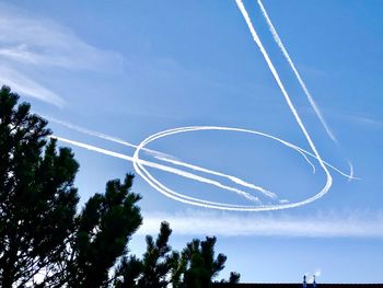 Low angle view of vapor trail against blue sky