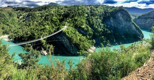 High angle view of river amidst trees against sky
