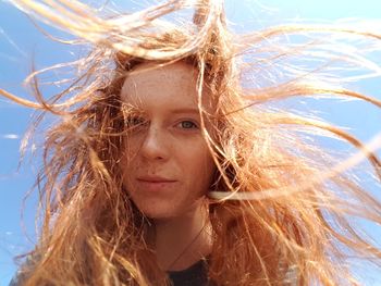 Low angle portrait of redhead woman