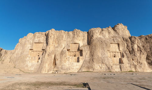 Rock formations against clear blue sky