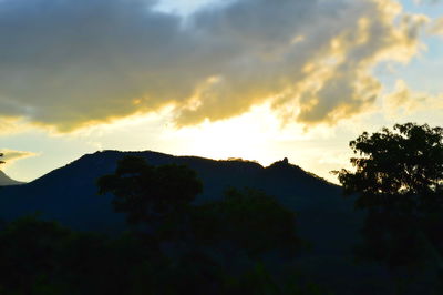 Scenic view of silhouette mountains against sky at sunset