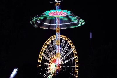 Low angle view of ferris wheel at night