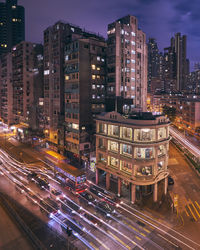 High angle view of illuminated city street and buildings at night