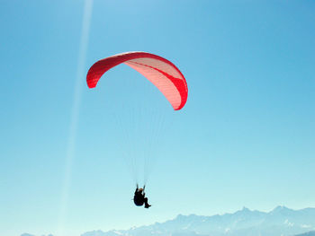 Paragliding in the alps in winter, outdoor sports in the mountains