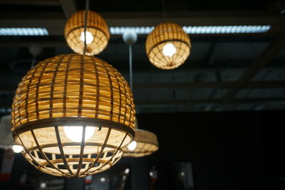 Low angle view of illuminated pendant lights at night