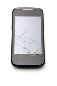 Broken mobile phone on white background