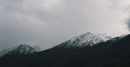 Scenic view of mountains against cloudy sky