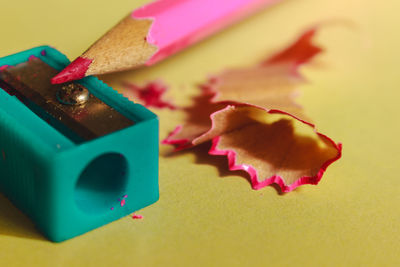 Close-up of colored pencil and sharpener on table