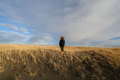 Rear view of man walking on field