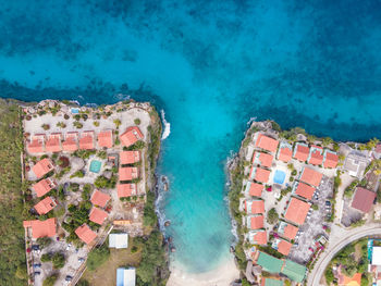 High angle view of buildings by sea