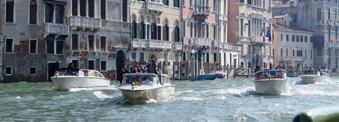 People on motorboats in canal