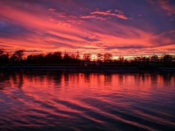 Scenic view of lake against romantic sky at sunset