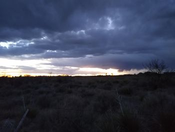 Scenic view of field against sky at sunset