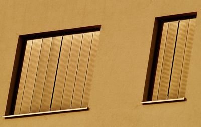 Low angle view of window on building wall