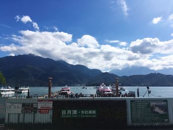 Scenic view of sea and mountains against sky