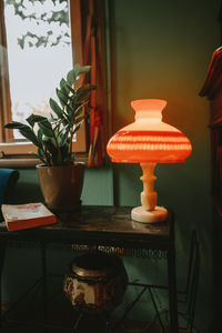 Close-up of lamp on table at home