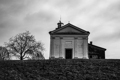 Black and white photo of a small church on the top of the hill in mare di lugo, vicenza, italy