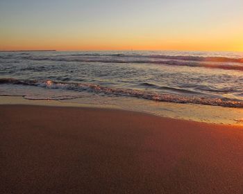 Scenic view of beach against sky during sunset