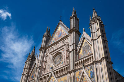 Low angle view of temple building against blue sky