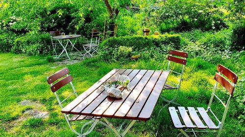 High angle view of empty chairs and table in park