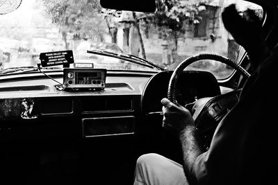 Cropped image of man driving taxi