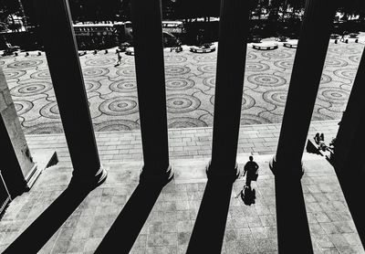 Shadow of people walking on bridge