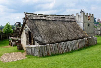 Old house on field against sky