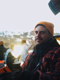 Portrait of young man sitting outdoors