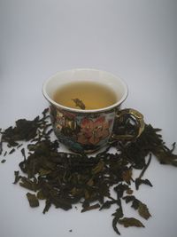 Close-up of tea cup against white background