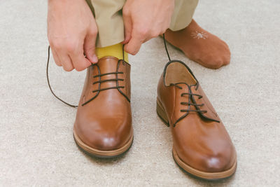 Low section of man wearing leather shoes