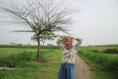 Full length of woman standing on field