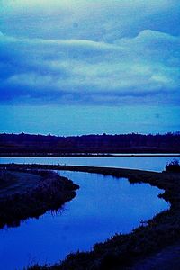 Reflection of trees in lake against sky