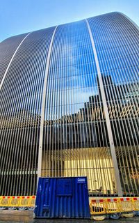 Low angle view of modern building against clear blue sky