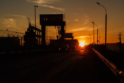 Traffic on road at sunset