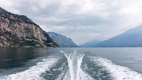 Scenic view of sea and mountains against sky